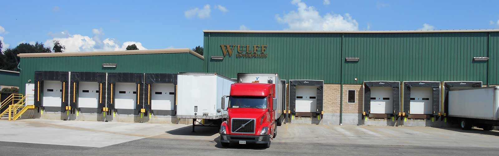 Red cab of Wulff Enterprises tractor-trailer at Wullf loading dock.