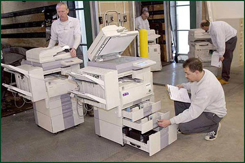 Wulff repair technicians testing copiers.