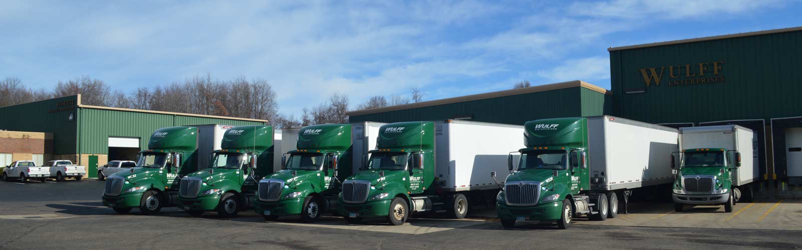 Four Wulff Enterprise tractor-trailers with Wulff logos on cabs.